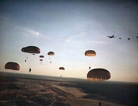 "US_Army_Rangers_parachute_into_Grenada_during_Operation_Urgent_Fury.jpg" by User:Hohum