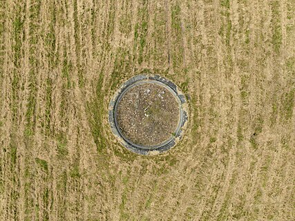 Defunct fountain surrounded by mowed lawn in Znamenka estate. Peterhof, Saint Petersburg, Russia.