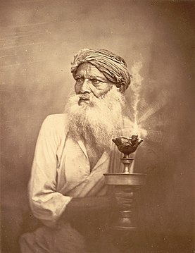 "Portrait_of_an_old_man_with_a_lamp_in_Eastern_Bengal_in_the_1860s.jpg" by User:Co9man