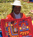 "Indigenous_woman_of_Peru_showing_her_traditional_textiles.png" by User:Ethanzr